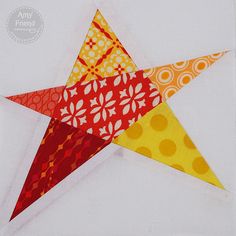 an orange, yellow and red star on a white background