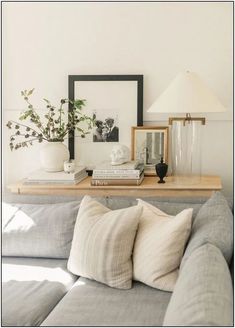 a living room with a couch, table and pictures on the wall next to it