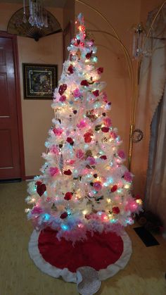 a white christmas tree with red and blue lights