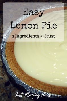 an easy lemon pie with white frosting in a tin foil pan on a granite countertop