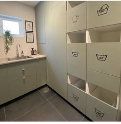 a kitchen that has some boxes on the wall in front of it and a sink