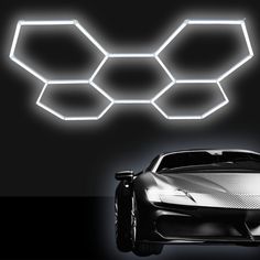 a futuristic car with three hexagonal lights above it