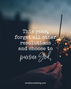 someone holding a sparkler with the words, this year forget all other resolutions and choose to pursue god