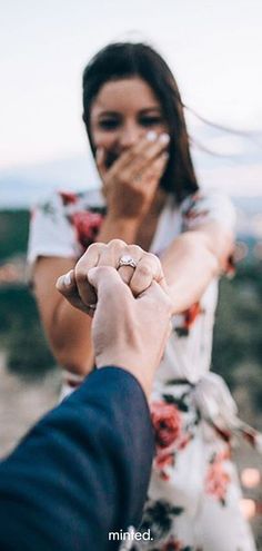 a man holding the hand of a woman