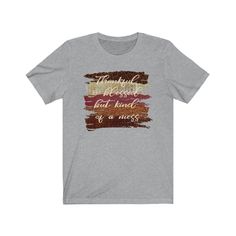 "\"Thankful and blessed but kind of a mess\" t-shirt This trendy fall shirt with autumn brush strokes is a perfect way to show your love of fall and all the colors of the fall season. This adorable fall shirt with a funny saying will be a great addition to your fall wardrobe. Wear this fall t-shirt with a pair of jeans, boots and a jacket or cardigan and you'll be stylin' for the season. CARE INSTRUCTIONS Design is professionally transferred using commercial grade equipment for a beautiful and d Fall Soft-washed Tri-blend T-shirt, Soft-washed Tri-blend Fall T-shirt, Inspirational Graphic Print T-shirt For Fall, Inspirational Cotton T-shirt For Fall, Instructions Design, Lyric Shirts, Blessed Shirt, Jeans Boots, Autumn Quotes