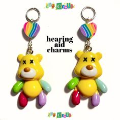 two colorful teddy bears are hanging from earrings