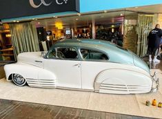 an antique car on display in front of a building