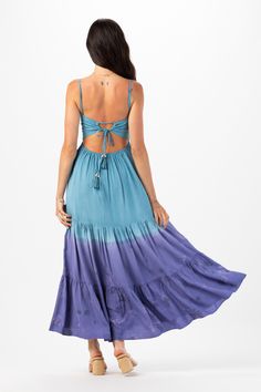 With its floor-grazing length, the Avisa Maxi Dress exudes bohemian elegance, making it perfect for everything from beach weddings to summer soirées. Whether you're dancing under the stars or strolling along the shore, this dress is sure to make you feel like a goddess. Details: 100% Rayon Hand Wash in Cold Water and Lay Flat to Dry Features: Unlined, Smocked Bodice, Self-tie spaghetti strap closure, Tassel tie detail on straps, Open back detail for an adjustable fit, Tiered Maxi Skirt. Measurem Beachy Dresses For Summer Beach Wedding, Beachy Summer Dresses For Beach Wedding, Summer Beach Wedding Dress In Beachy Style, Floor-length Tie Back Maxi Dress For Beach, Blue Floor-length Maxi Dress For Festival, Breezy Tie Back Dresses For Beach Season, Blue Bohemian Maxi Dress For Summer, Bohemian Floor-length Maxi Dress With Tie Back, Flowy Breezy Boho Maxi Dress