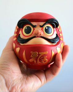 Make a wish! It's simple, we draw one eye when the objective is set, then the other when it is achieved. Daruma is a powerful symbol of motivation and determination. It encourages you to stay focused on your goals and persevere until they are achieved! Discover unique handcrafted figurines to motivate you in your goals and bring luck into your life. Order now on Etsy and be inspired by this traditional Japanese object with a modern design! Werewolf Card Game, Werewolf Card, Fake Skin Tattoo, Japanese Statue, Stay Focused On Your Goals, Japanese Christmas, Japan Graphic Design, Japanese Symbol