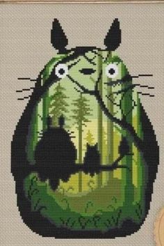 a cross stitch pattern with an animal in the woods