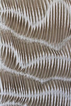 the texture of fabric is made up of wavy lines and curves in shades of beige