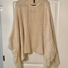 Elan Cream Fringe Poncho, Never Worn. Oversized Fringe Cape Poncho, Long Sleeve Fringe Poncho, Cozy Spring Poncho With Batwing Sleeves, Cozy Batwing Sleeve Poncho For Spring, One Size Batwing Sleeve Cape For Spring, Cream Winter Cape Poncho, Winter Cream Poncho Cape, Oversized Cream Shawl Poncho, Cream Poncho Cape For Winter