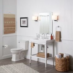 a bathroom with white walls and wood floors