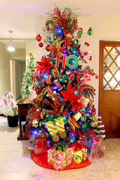 a brightly colored christmas tree with presents on it