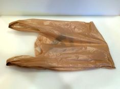 a brown plastic bag sitting on top of a table