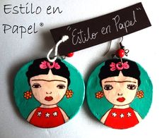 a pair of earrings with fridas painted on them