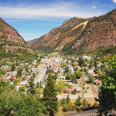 a small town nestled in the mountains surrounded by trees