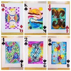 four cards with different designs on them, each featuring an image of a cat and other animals