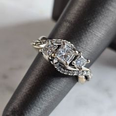 A Womens Vintage Estate 14k White Gold Diamond Ring. The Ring Weighs 6.7g And Is A Size 5.75. The Width Of The Ring Is About 3/8". The Carat Weight Of The Three Center Diamonds Are About 0.91cts, Accented With 24 Side Diamonds. Ring Is Marked "14k" . Any Questions Please Ask Prior To Purchasing. Be Sure To Check Out Some Of My Other Great Items Up For Sale. Thank You 14k White Gold Cluster Ring With Vs Clarity, Exquisite Vs Clarity Diamond Ring For Anniversary, Sterling Silver Three Stone Baguette Cut Ring, Dazzling 14k Gold Princess Cut Jewelry, Vs Clarity Princess Cut Promise Ring, Princess Cut 14k White Gold Jewelry, Classic Cubic Zirconia Bypass Wedding Ring, Sterling Silver Bypass Ring For Wedding, Fine Jewelry Sterling Silver Bypass Ring For Wedding