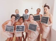 a group of women holding up signs in front of them