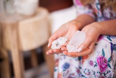 a woman is holding two pieces of soap in her hands with the word shop written on it