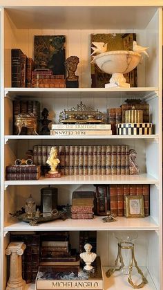 a book shelf filled with lots of books and other items on top of it's shelves