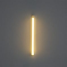 a light that is on the side of a wall with a long tube attached to it