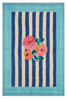 a blue and white striped wall hanging with pink flowers on the front, along with horizontal stripes