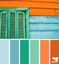 an orange and blue house with green shutters