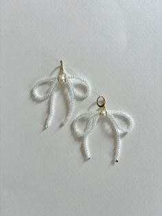 White Bow Earrings Handmade White Dangle Clip-on Earrings, Adjustable White Crystal Earrings, White Clip-on Hoop Earrings As Gift, White Clip-on Hoop Earrings For Gift, White Crystal Drop Earrings With Ear Wire, White Dangle Clip-on Hoop Earrings, White Dangle Clip-on Pearl Earrings, White Dangle Pearl Clip-on Earrings, White Pearl Dangle Clip-on Earrings