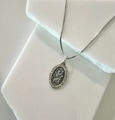 (Photo Enlarge to Show Detail)✨ Discover divine elegance with our Sterling Silver Saint Christopher Pendant. Crafted with exquisite detail, this 28mm oval pendant features an antiqued Virgin Mary, radiating timeless grace and spiritual significance. The intricately designed pendant is a symbol of faith, protection, and devotion. Made of sterling silver, it boasts enduring quality and beauty. Complete your ensemble with the optional 1.3mm box necklace, crafted from the same sterling silver for a seamless look. Whether worn for religious significance or as a fashion statement, this pendant exudes sophistication and reverence. Embrace the divine with this exquisite piece, a timeless addition to any jewelry collection. 🌟 Add the optional 1.3mm box chain for extra shine and versatility in leng St Christopher Necklace, St Christopher Pendant, Box Necklace, First Communion Gifts, St Christopher, Saint Christopher, Necklace Box, Oval Pendant, Fine Jewellery Necklace