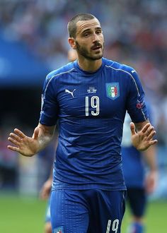 a soccer player with his hands out on the field