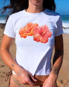 Say hello to summer with the "Hibiscus Baby Tee"! 🌺 This beachy, Coconut Girl tee brings tropical vibes straight to your wardrobe. With its vibrant hibiscus graphic and relaxed fit, it's the perfect match for sunny days and easygoing style. Made from ethically grown US cotton and eco-friendly dyes, this tee is as kind to the planet as it is to your skin. Style it with shorts, skirts, or layered under a jacket for effortless summer chic. Don't forget to check the size chart for the perfect fit! Feel free to reach out with any questions--I'm here to help. <3 Keywords: Hibiscus Baby Tee, Coconut Girl style, summer graphic tee, beachy vibes, ethical fashion, eco-friendly clothing, StarGirl Collective, trendy baby tee, casual chic, sustainable style. Beachy Fashion, Tropical Top, Coconut Girl Aesthetic, Personal Things, Graphic Baby Tee, Beachy Summer, Winter Outfits Aesthetic, Summer Graphic Tee, Beachy Vibes