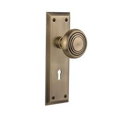 an antique brass door handle with a round knob