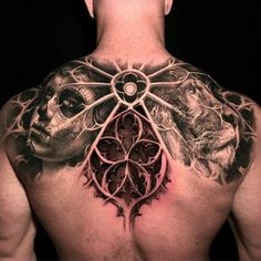 a man's back with tattoos on his chest and the image of two lions