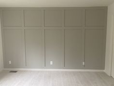 an empty room with white walls and no furniture on the floor in front of it