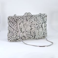 New to our Millennium collection, This beautiful romantic bridal clutch bag is made of very fine quality of rhinestones and metal and it comes with two chains, one chains length is 15 inches for a shoulder bag 45 inches long cross body bag Detachable chain for your Big day! Dimensions- Depth of the bag is 2 inches, length oh the bag is 7.5 inches and width of the bag is 4.5 inches.   ► ABOUT YOUR ORDER * All items are neatly packaged in our beautiful jewelry boxes and elegant organza bags. * All Elegant Wedding Clutch With Bling, Glamorous Bedazzled Evening Bag For Wedding, Silver Handheld Clutch With Rhinestones, Silver Embellished Crystal Clutch, Rhinestone Clutch For Wedding Guest, Crystal Embellished Evening Clutch, Elegant Bedazzled Rectangular Evening Bag, Elegant Bedazzled Bag For Events, Luxury Silver Bedazzled Bags