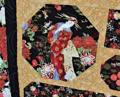 a close up of a patchwork quilt with an image of a woman in kimono