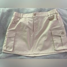 Khaki Cargo Skirt Never Worn Size Large Casual Khaki Mini Skort, Beige High Waist Mini Skirt With Pockets, Beige High-waist Mini Skirt With Pockets, Casual Beige Skirt With Pockets, Casual Beige Mini Skirt With Pockets, Casual Beige Mini Skirt, Amazon Casual Mini Skirt Bottoms, Casual Beige Relaxed Fit Skort, Casual Beige Skort