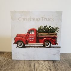 an old red truck with a christmas tree in the bed is shown on a white background