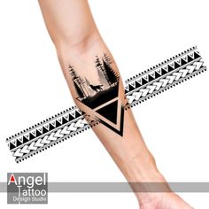 an arm tattoo with trees and mountains on it