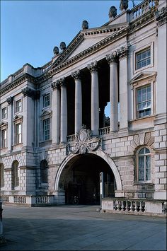 an old building with columns and arches on the front