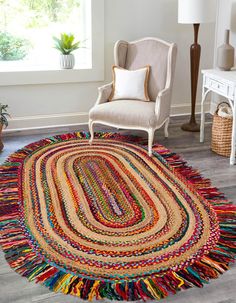 a round rug with multicolored fringes on the floor next to a chair