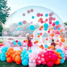 an inflatable bubble filled with colorful balloons