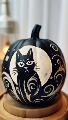 a painted pumpkin with a black cat on it