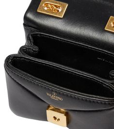 Valentino Garavani addresses your after-dark arm candy with this black crossbody bag. The design is made from padded leather with an envelope-style opening and iconic pyramidal hardware. material: lamb leather internal details: leather lining, internal slot pockets colour of fastening: antique gold chain shoulder strap Leather Crossbody Flap Bag With Gold-tone Logo, Leather Clutch Bag With Gold-tone Logo Plaque, Designer Flap Bag With Gold-tone Logo Plaque, Evening Crossbody Flap Bag With Gold-tone Logo, Luxury Crossbody Flap Bag With Gold-tone Logo, Designer Leather Flap Bag With Gold-tone Logo, Luxury Evening Flap Bag With Gold-tone Logo, Designer Gold Shoulder Bag With Turn-lock Closure, Luxury Evening Flap Bag With Turn-lock Closure