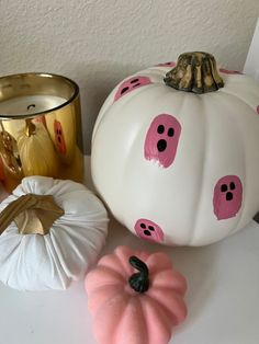 painted pumpkins and candles on a table