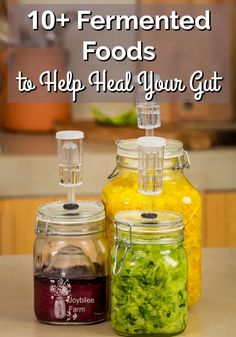 three jars filled with food sitting on top of a counter