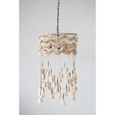 a white chandelier with tassels hanging from it