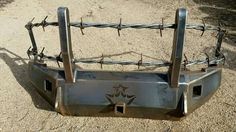 a close up of a metal object with barbed wire on it's sides and two holes in the middle